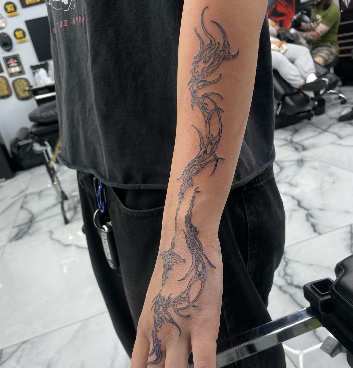 Abstract dragon black and grey tattoo on the forearm by Austin Jones