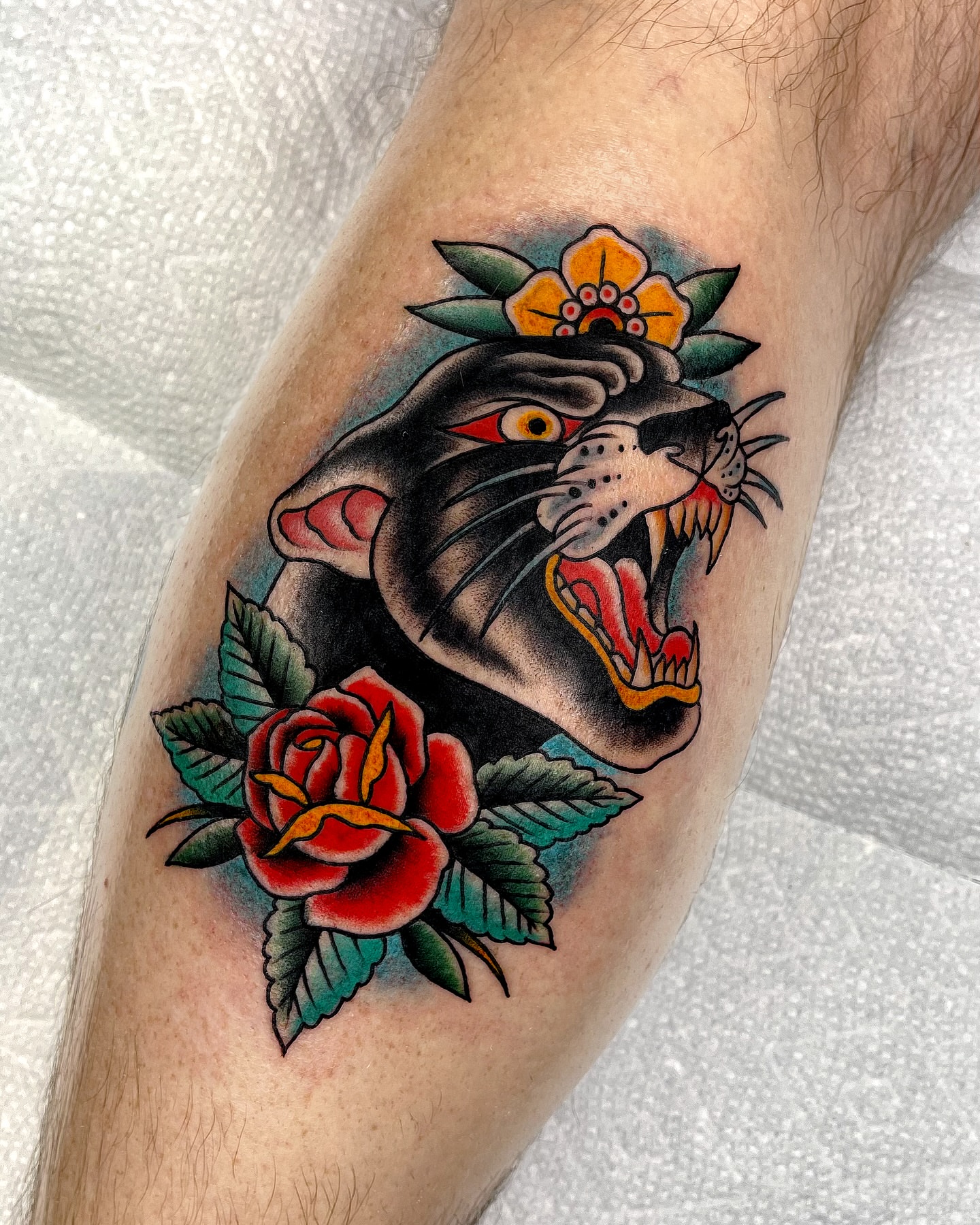 Panther and rose American traditional tattoo on the forearm by Lexx Christine