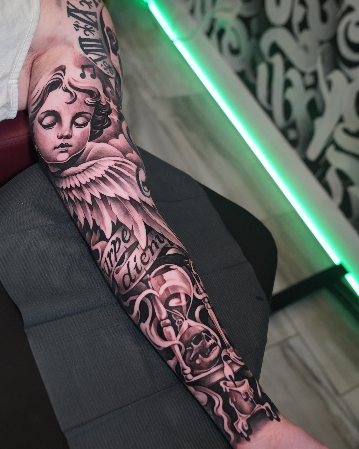 Angelic cherub neo-traditional tattoo on the forearm by Artem Kunakuzin