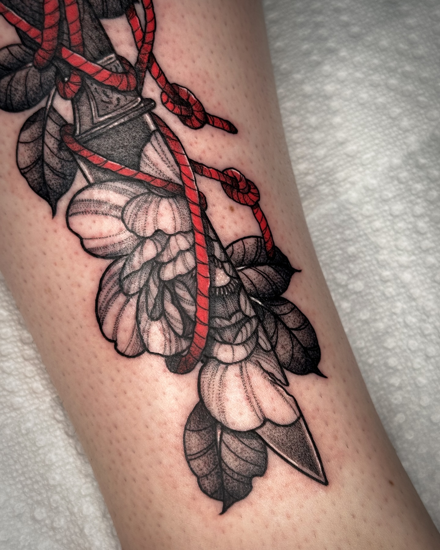 Rope and leaves black and grey tattoo on the forearm by Tony Murray