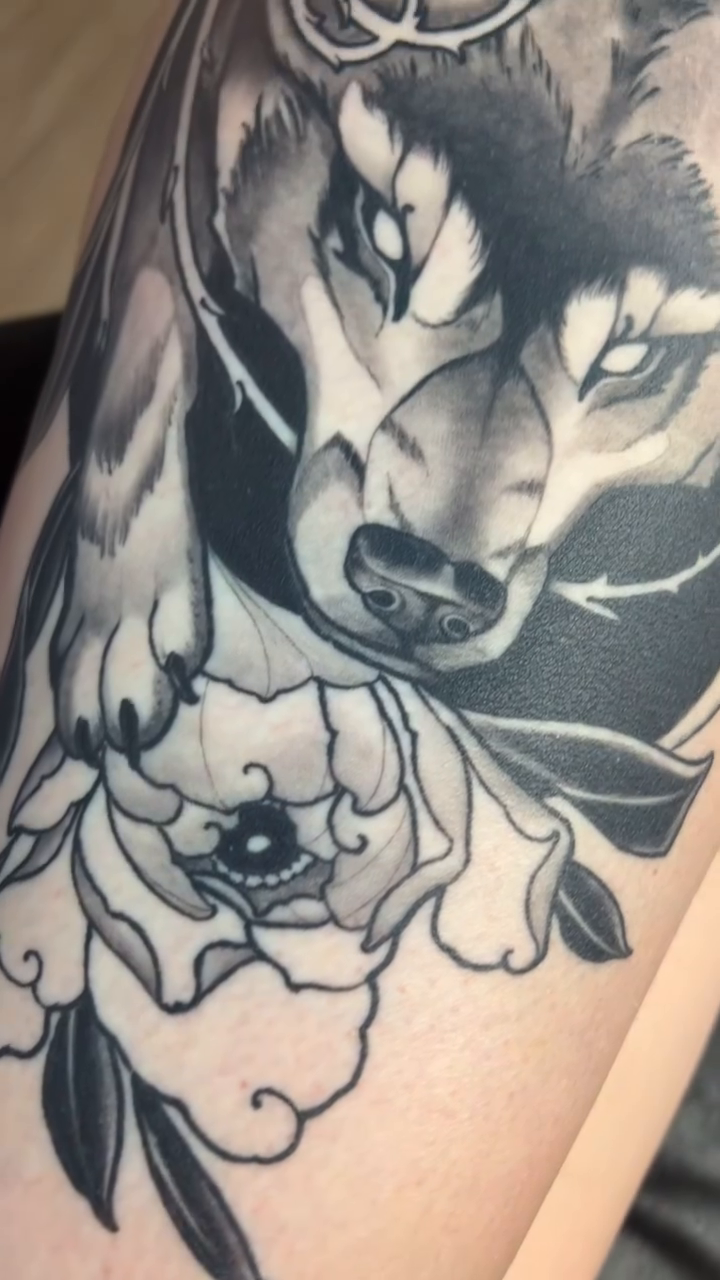 Wolf and flowers realism tattoo by Neo-Traditional tattoos in Las Vegas