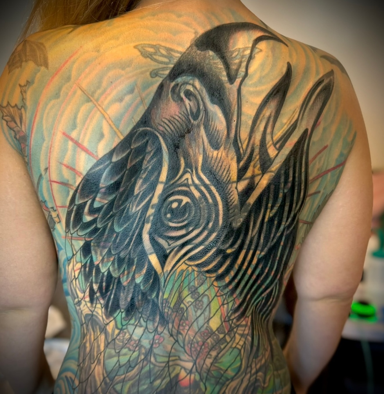 Bird realism tattoo on the back by Brian Hutflies