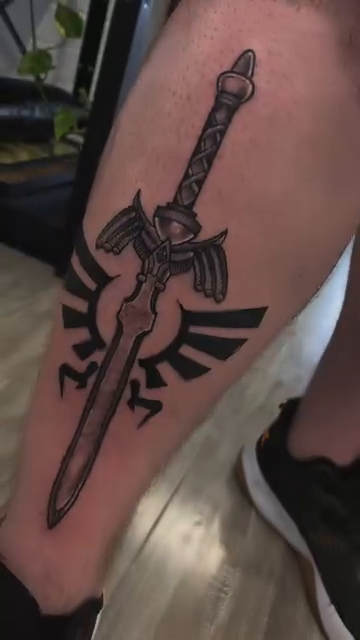Master Sword and Hylian Shield realism tattoo by Ryan Walker