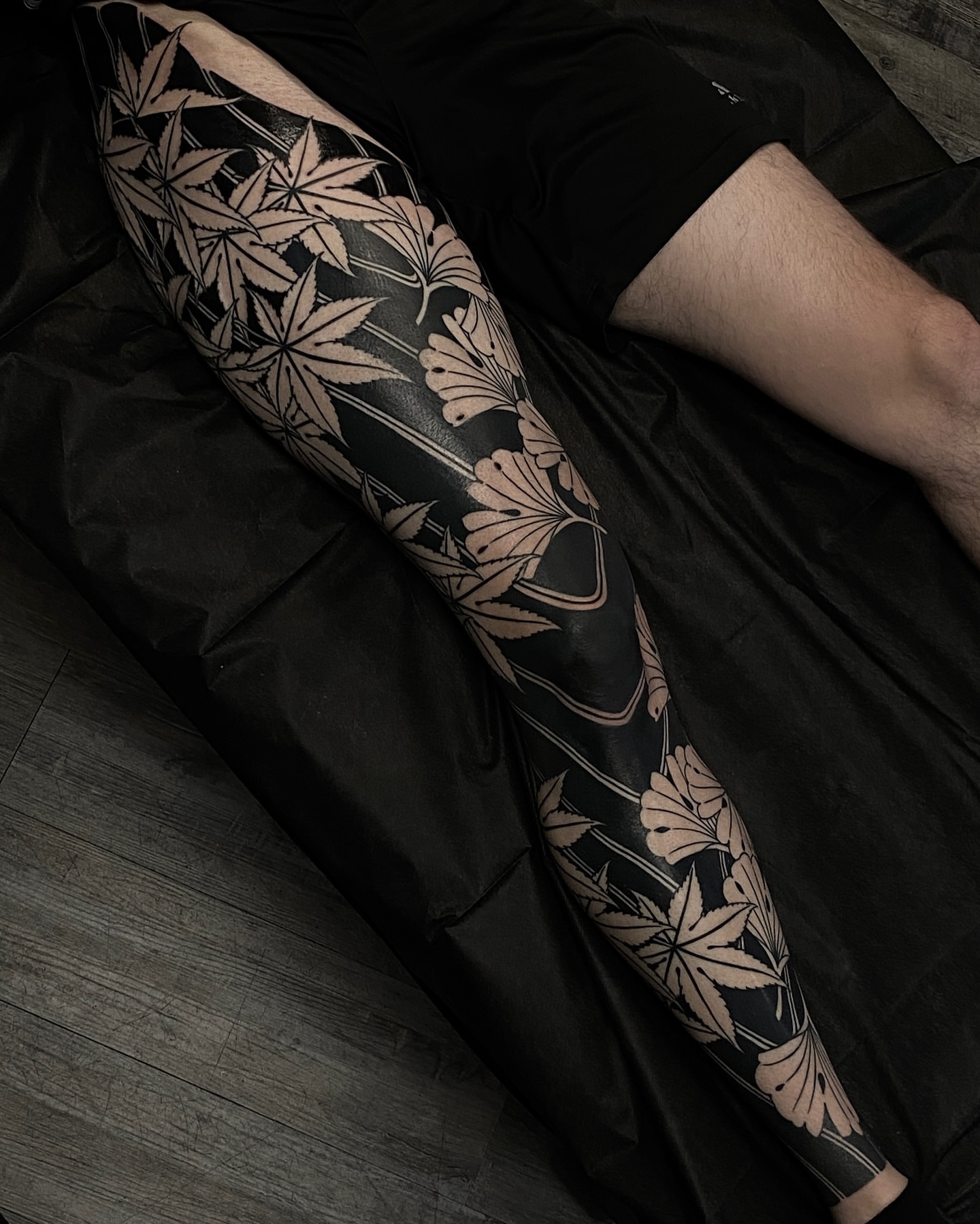 Marijuana leaves black and grey tattoo on the forearm by Tyler Charles