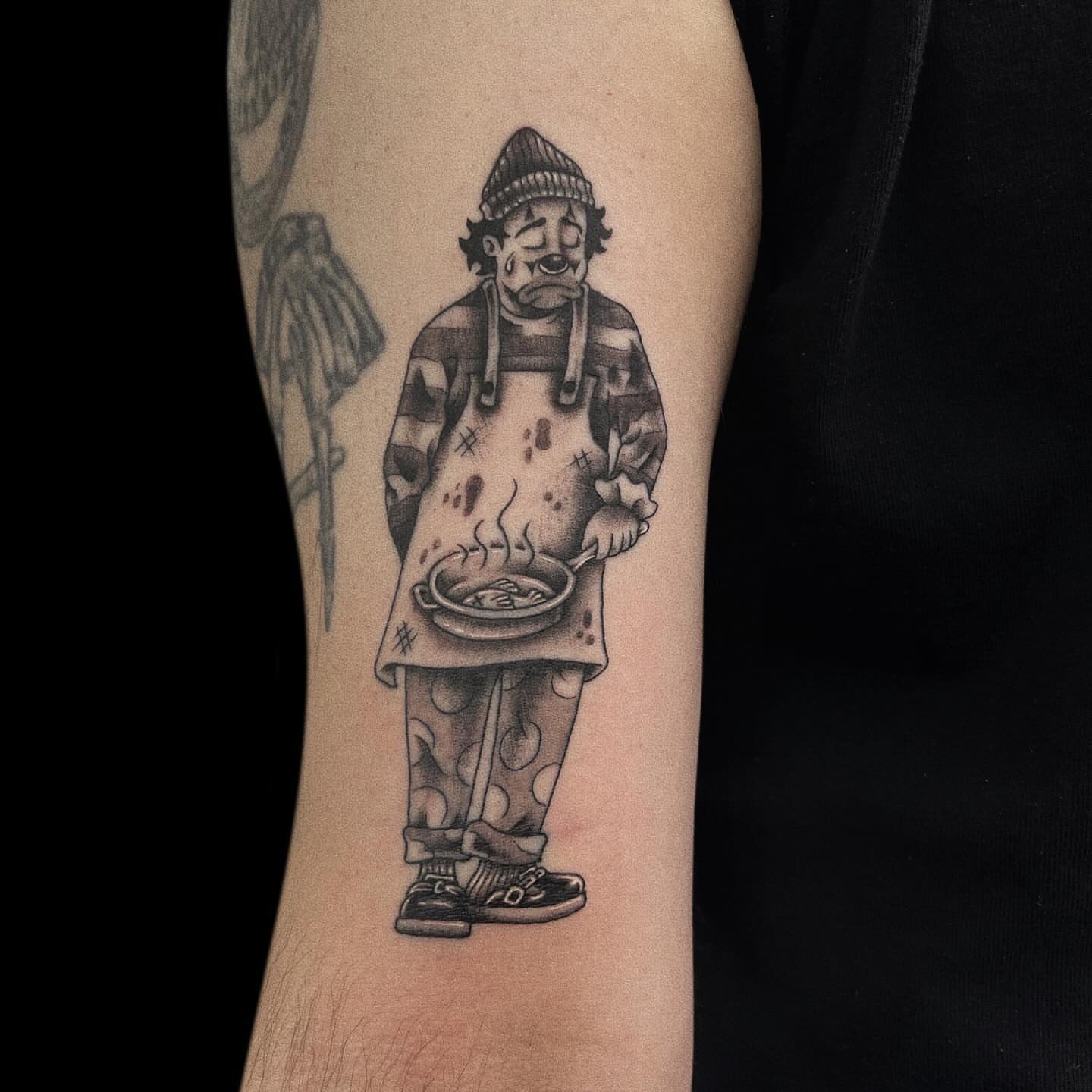 Clown cooking realism tattoo on the forearm by Jason