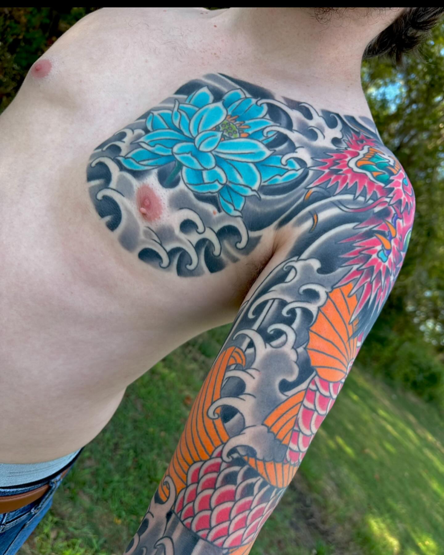 Koi fish and lotus flower japanese irezumi tattoo on the upper arm by Scott Allen Cooksey, Plano, Texas
