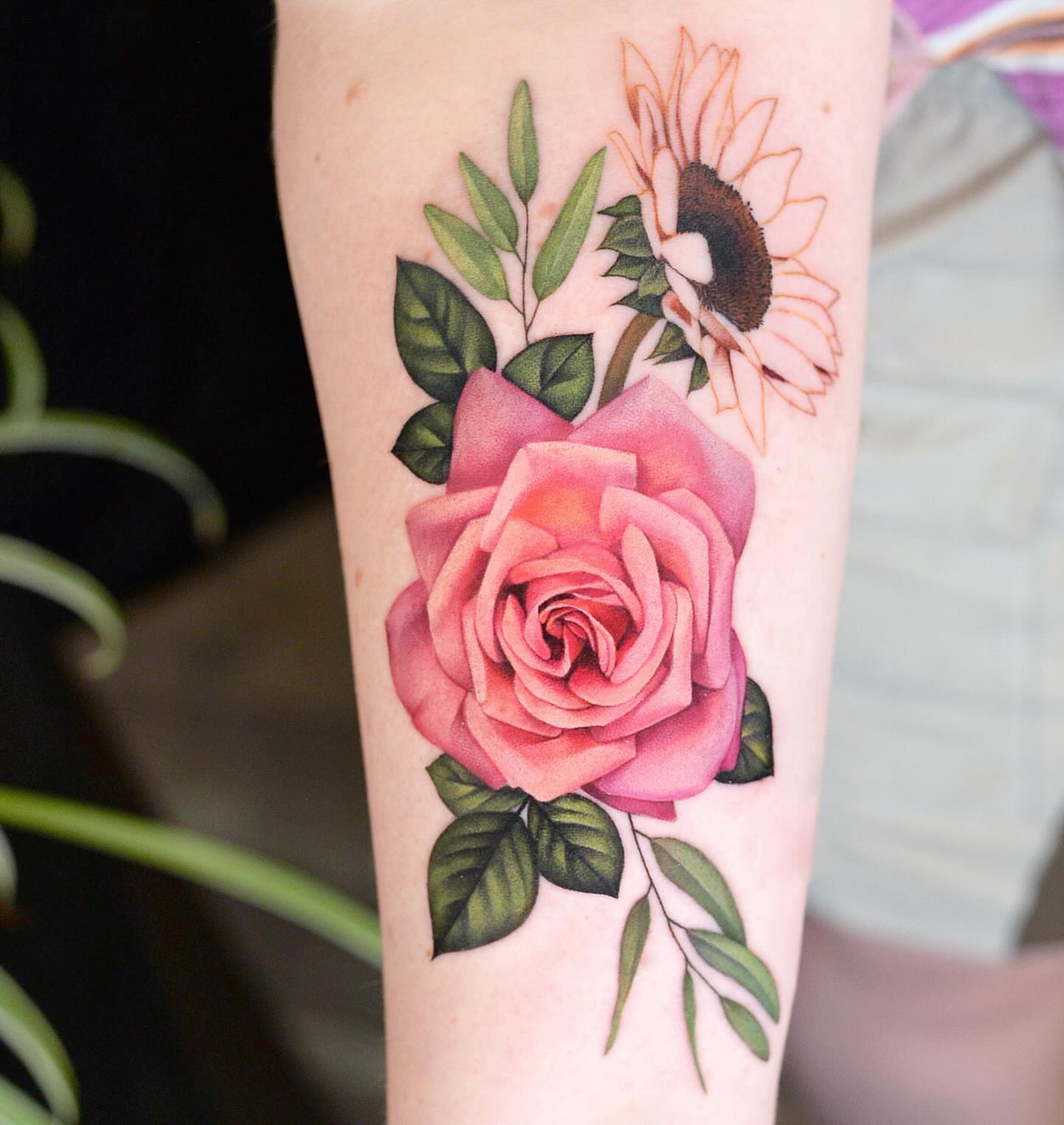 Rose and sunflower realism tattoo on the forearm by Joice Wang
