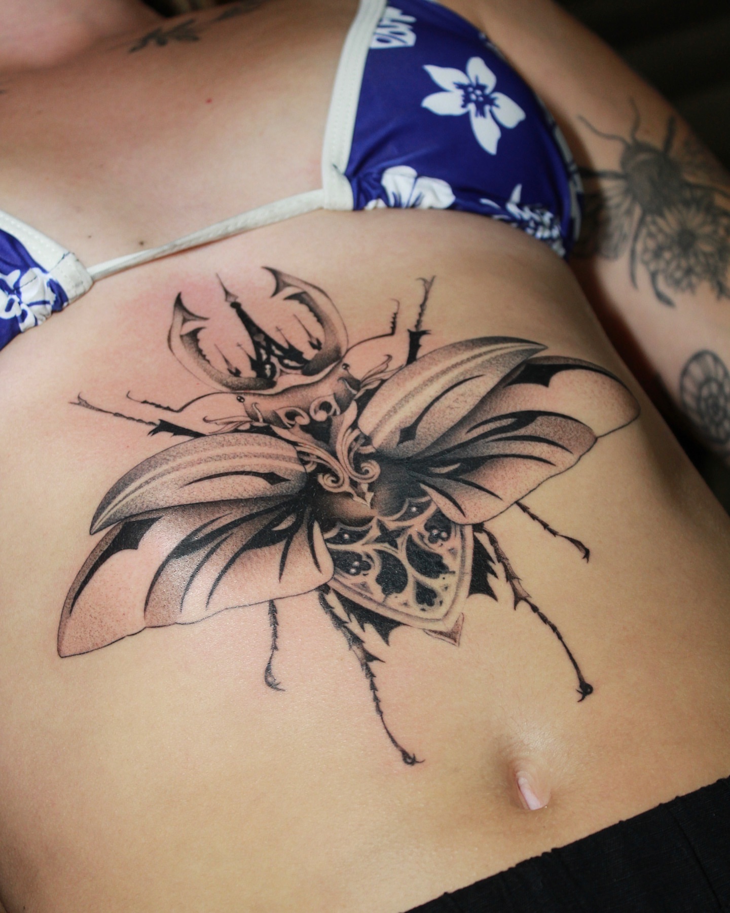Insect black and grey tattoo on the ribs by Beans