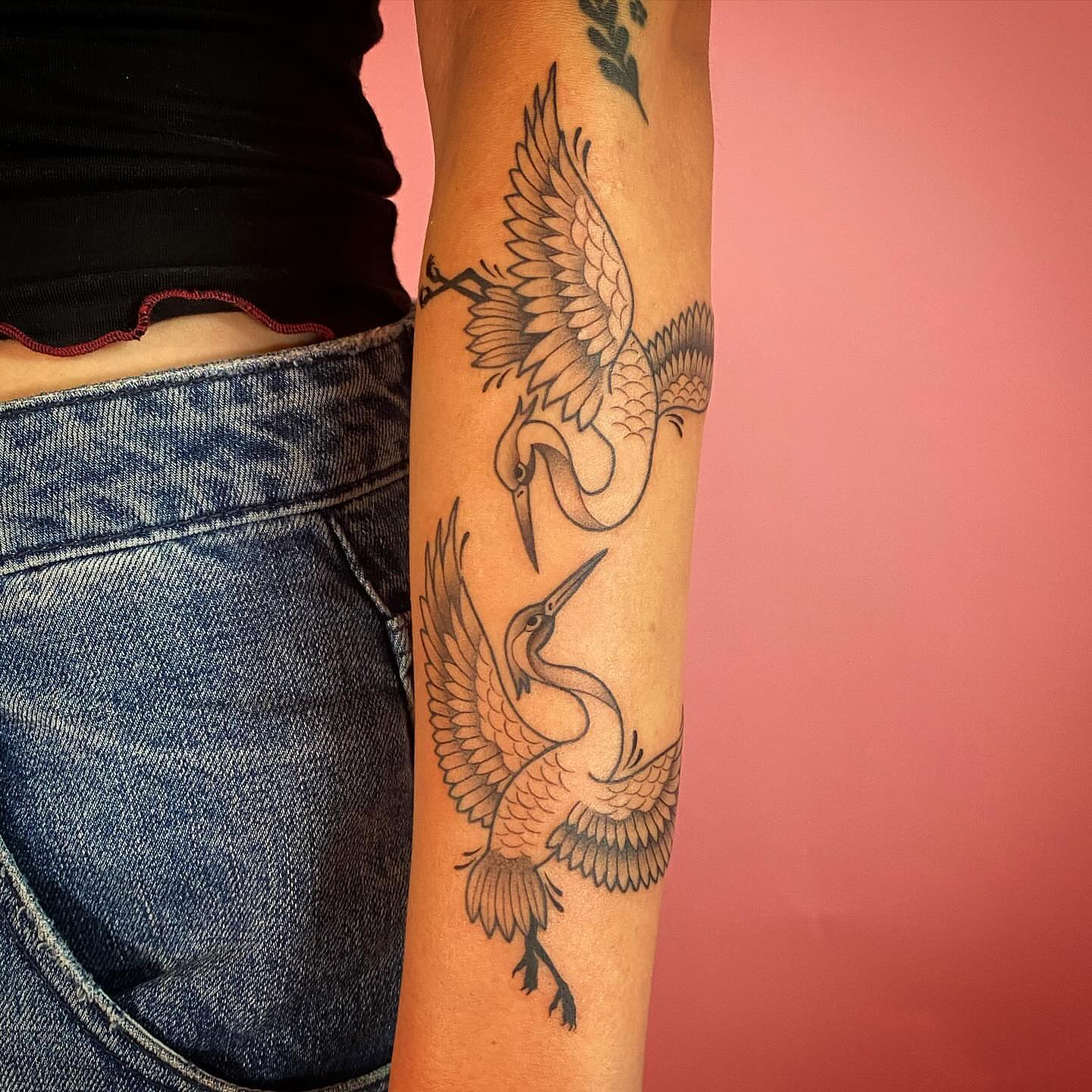 Cranes black and grey tattoo on the forearm by Barbara Niblo