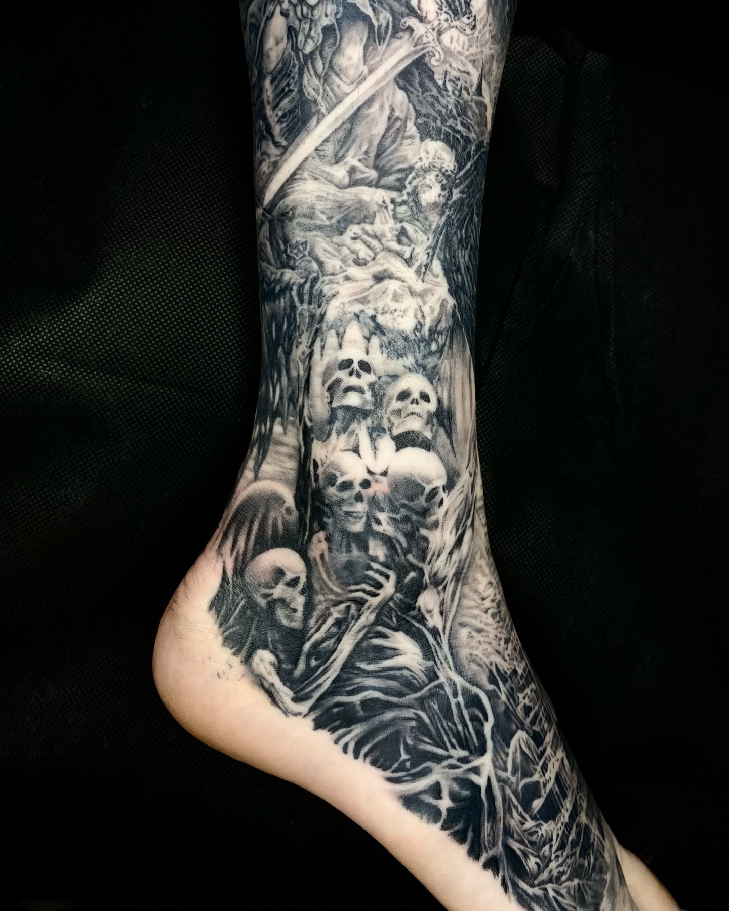 Skeletons and skulls realism tattoo on the foot by Gerardo Brawder