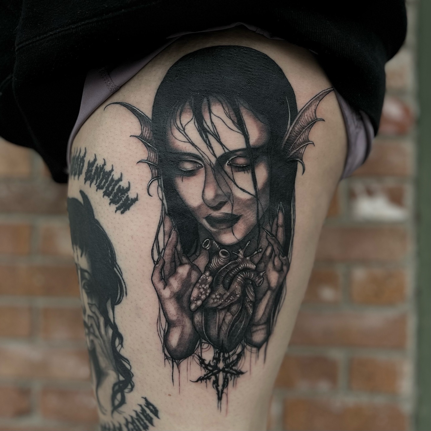 Woman with bat wings dark realism tattoo on the thigh by Myla Jane, Houston, Texas