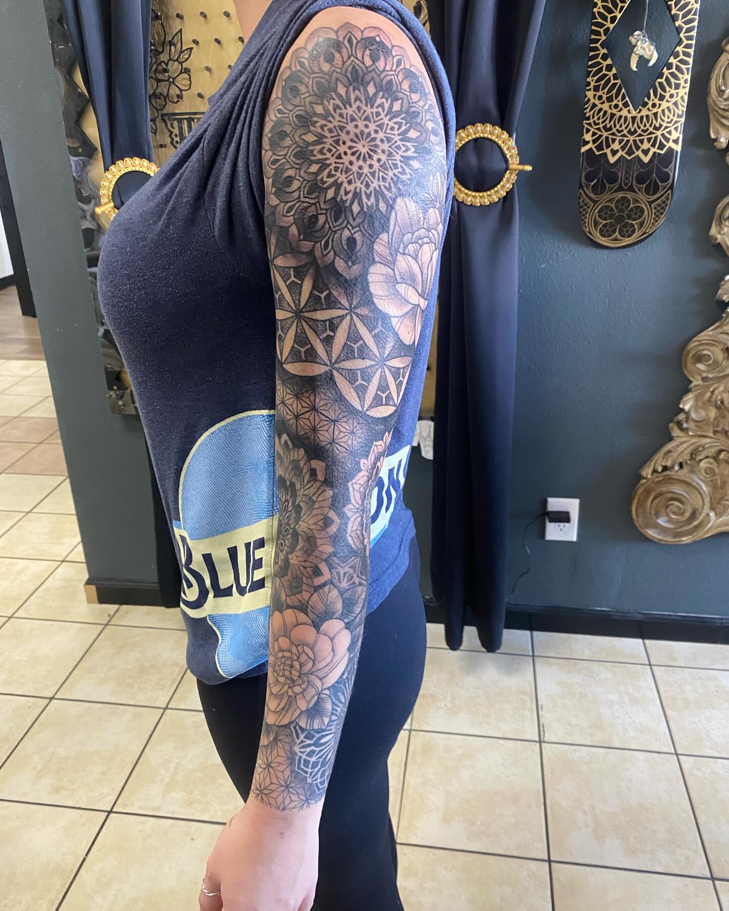 Floral mandala geometric tattoo on the upper arm by Nicholas Jones