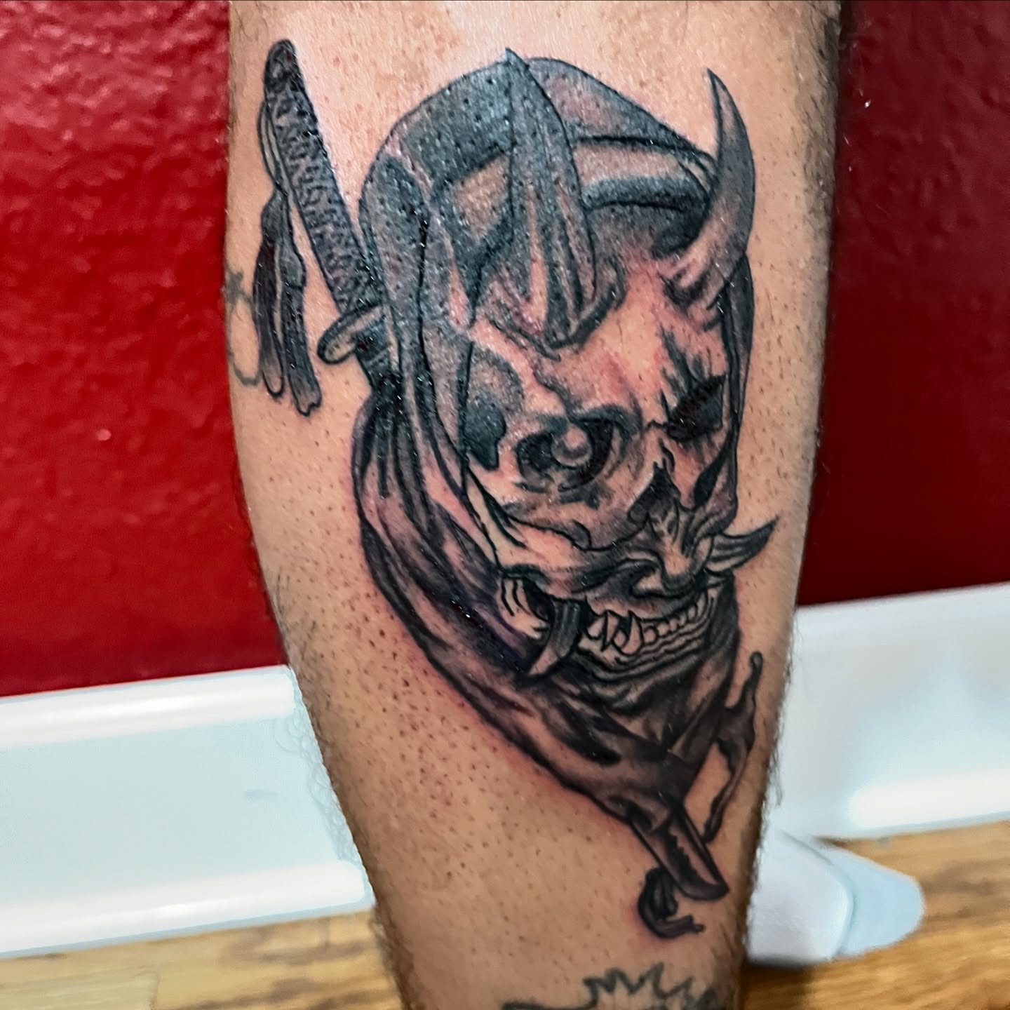 Demon mask realism tattoo on the forearm by Therapy ink