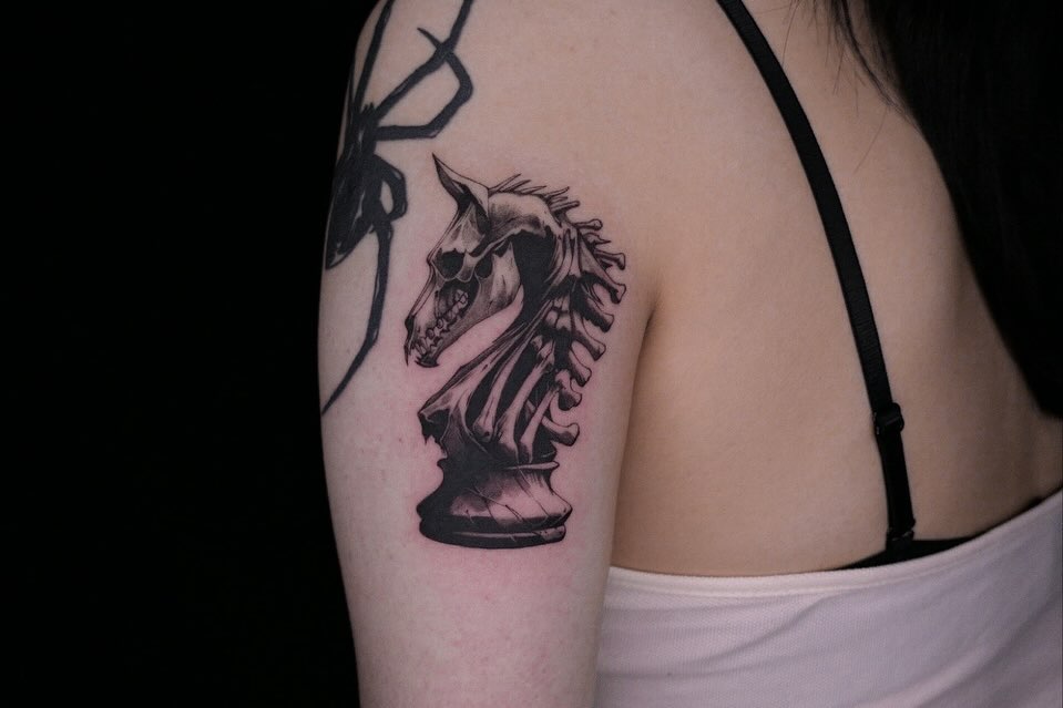 Chess knight black and grey tattoo on the shoulder by 𝑴𝒆𝒍𝒐