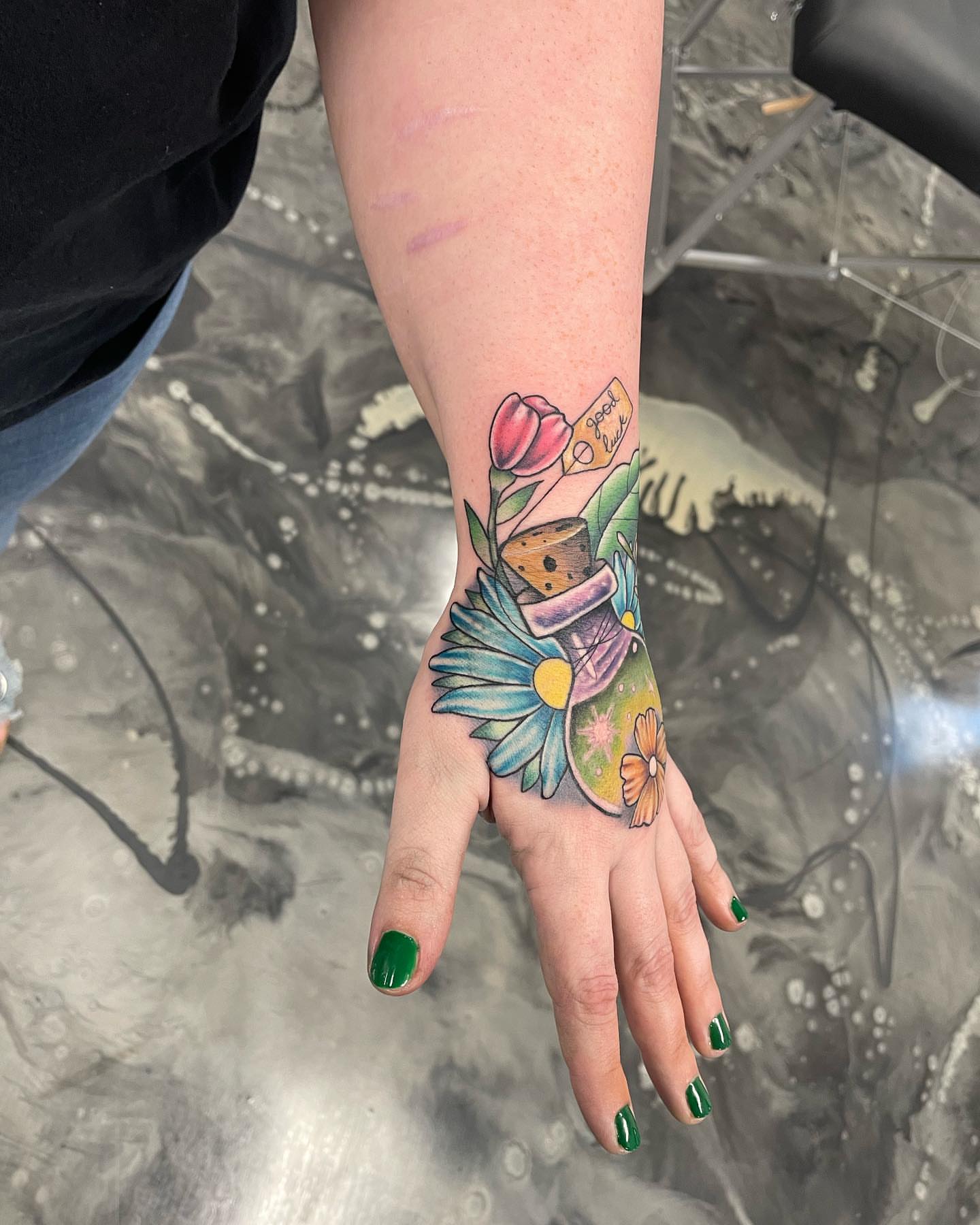 Teddy bear and flowers American traditional tattoo on the hand by Brandon Anderson