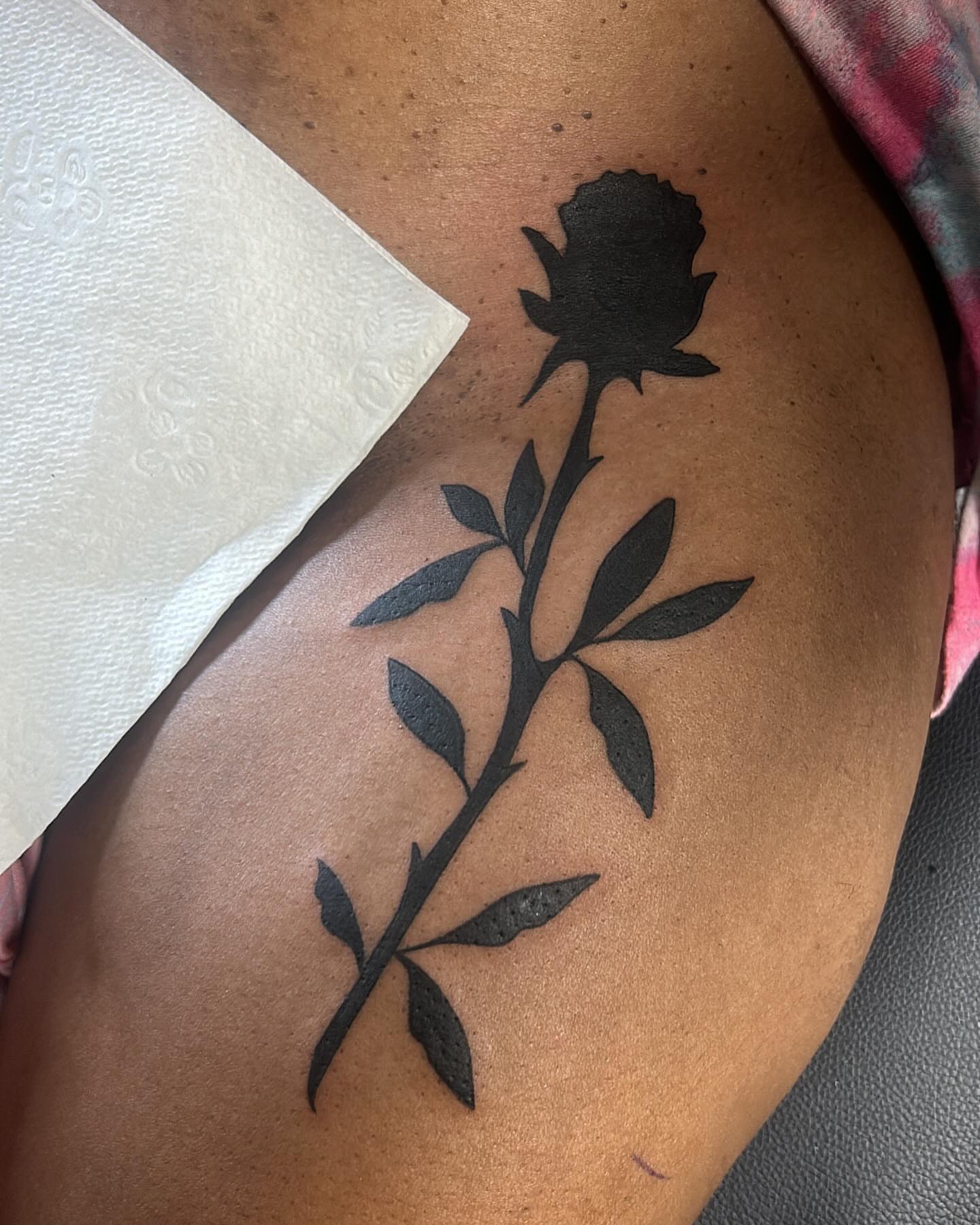 Rose black and grey tattoo on the thigh by Kells