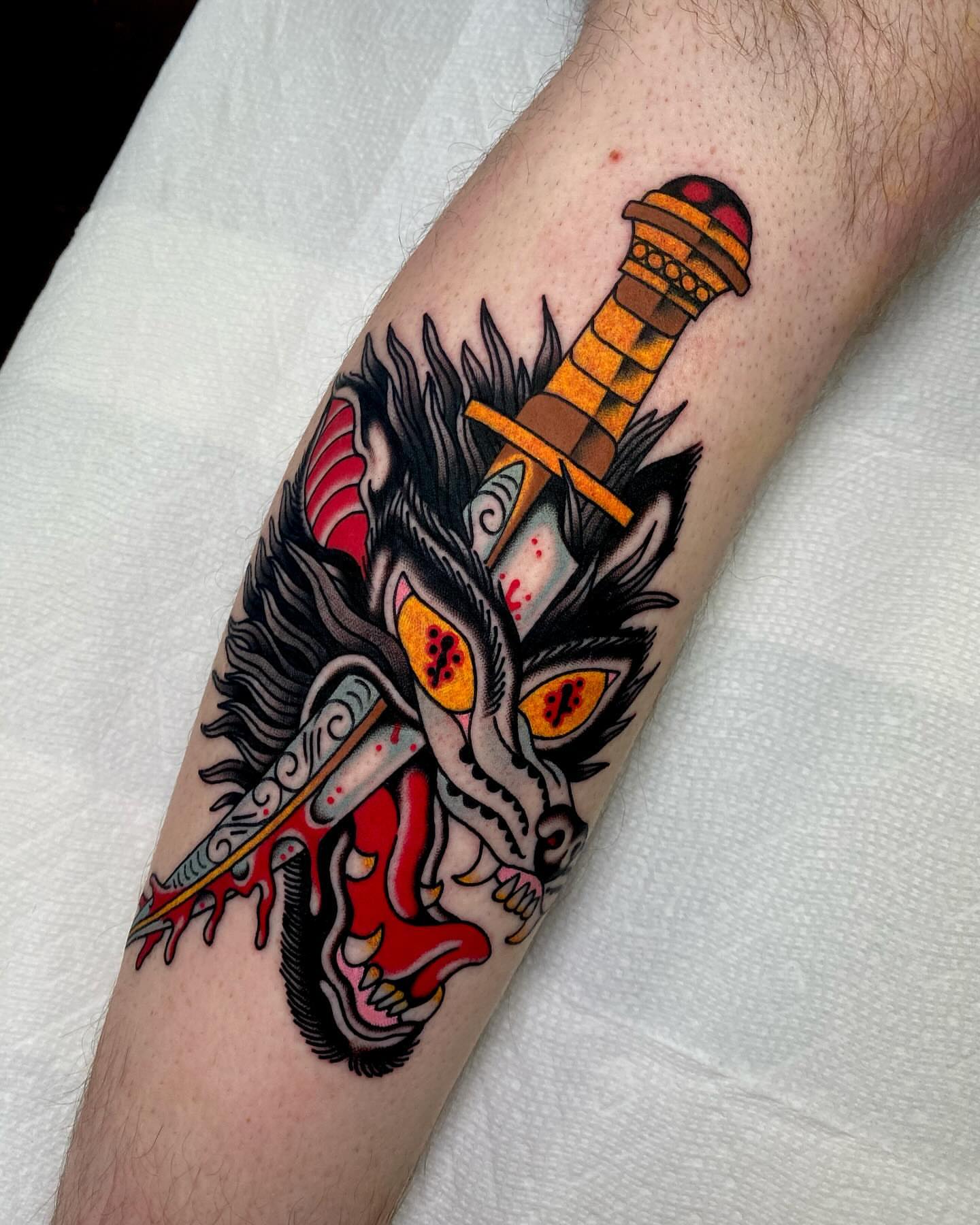 Demon mask with sword American traditional tattoo on the forearm by Justin R. Mitchell, Fort Worth, Texas