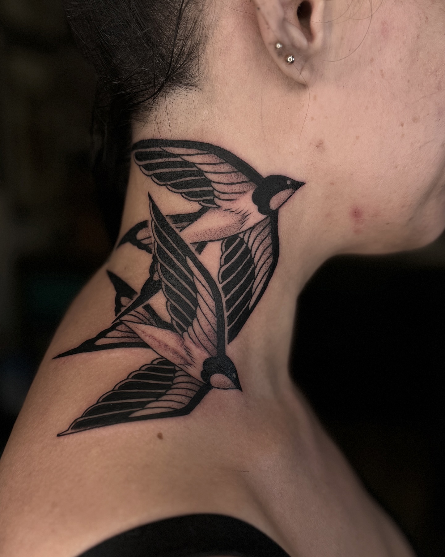 Swallow black and grey tattoo on the neck by Kyle Stacher - Blackwork Tattoos - Denver