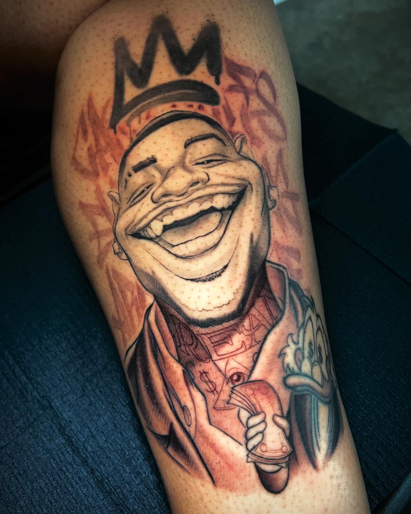 Laughing man with crown realism tattoo on the forearm by Tim Stafford