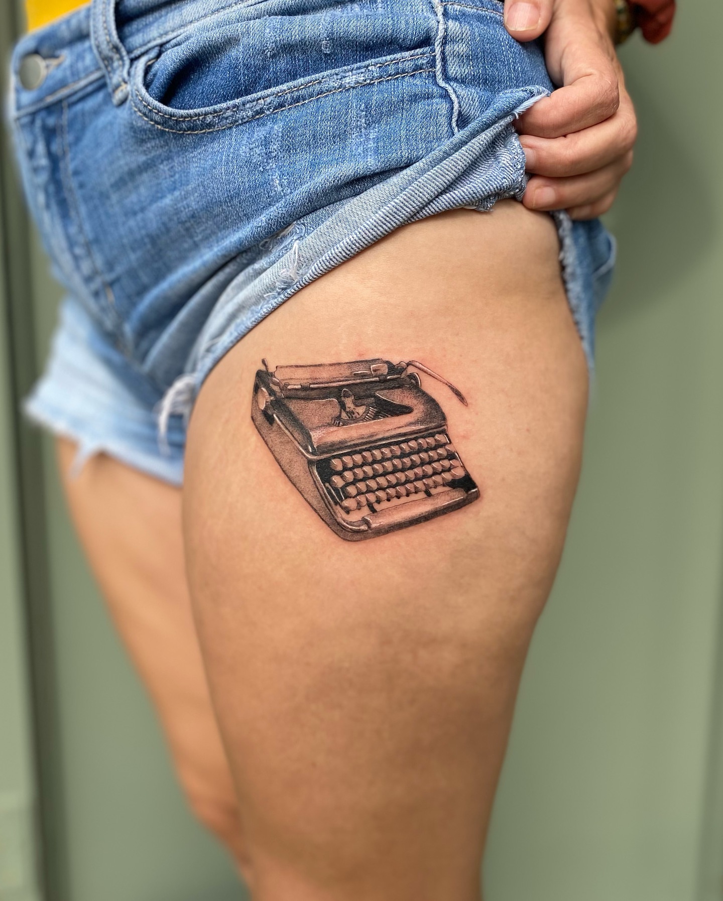 Typewriter realism tattoo on the thigh by Truett Payton