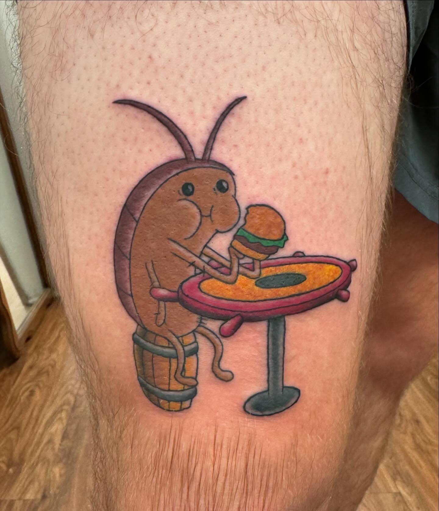Lobster eating burger illustrative tattoo on the thigh by McKenna Chalifoux