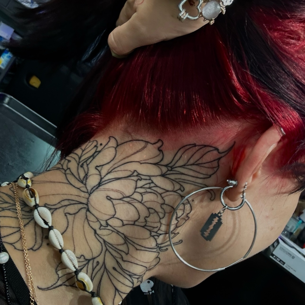 Floral design black and grey tattoo on the upper arm by Dee, San Diego, California