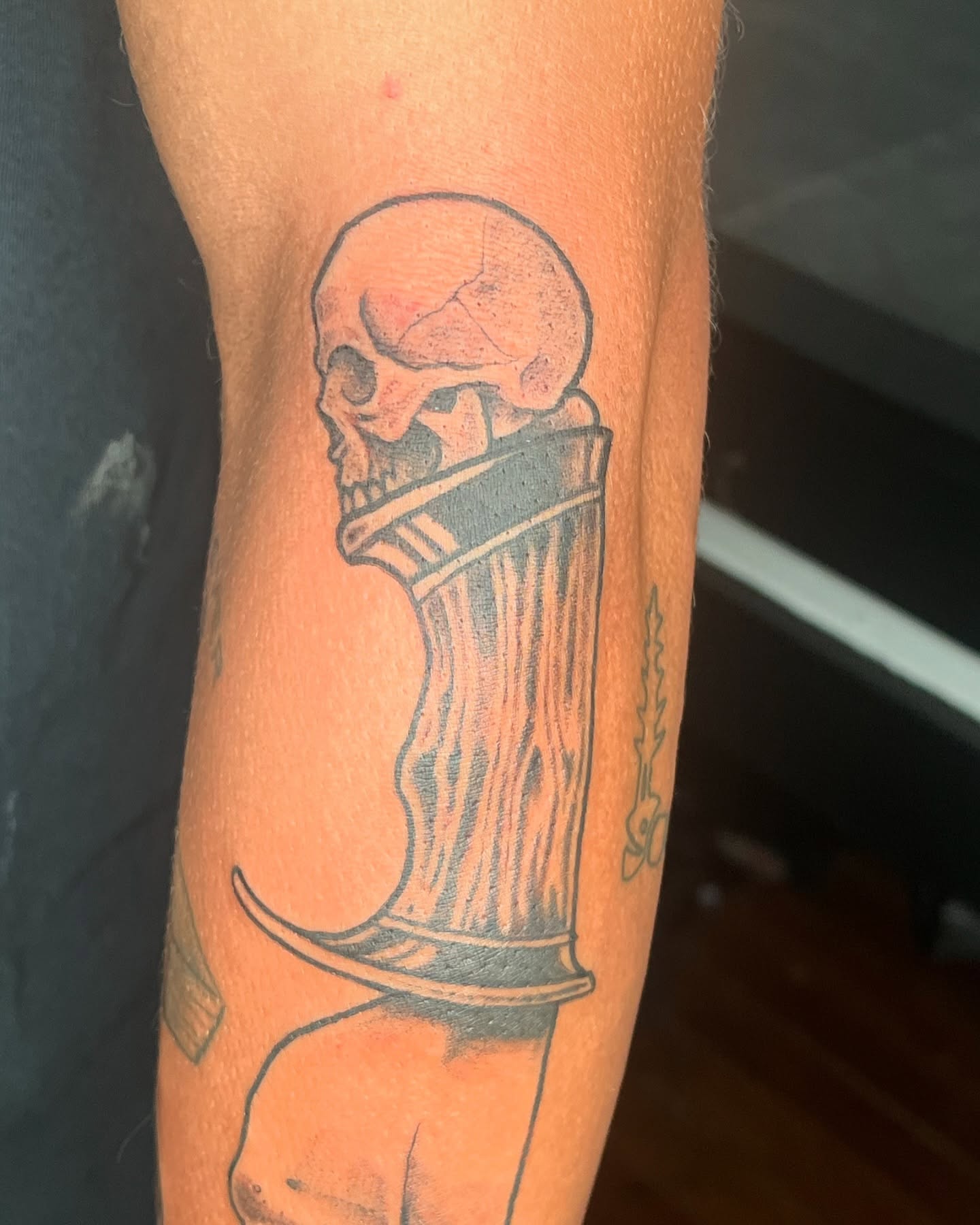 Skull and glass black and grey tattoo on the forearm by Vincent C DiBiaso, Covington, Kentucky