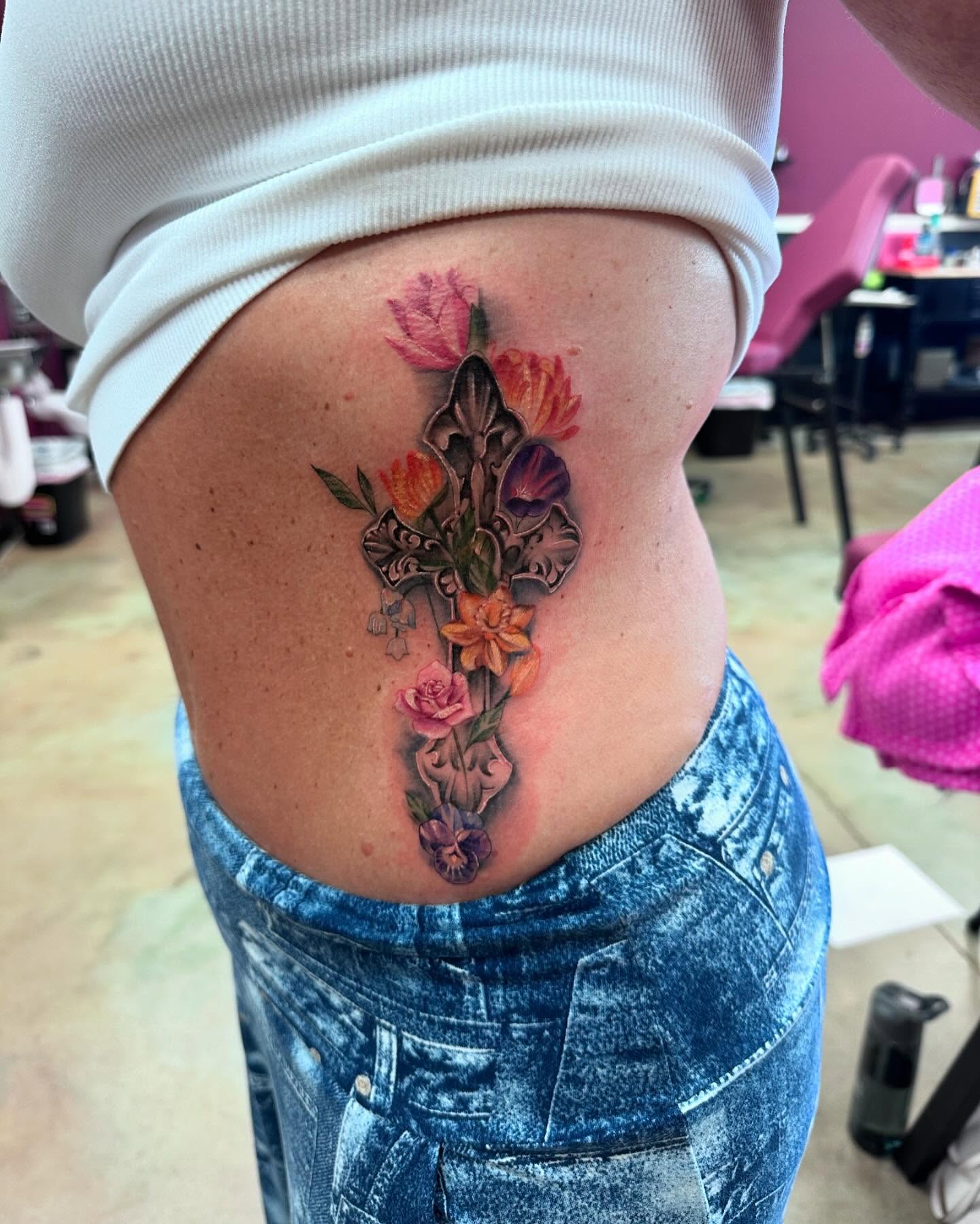 Floral arrangement realism tattoo on the thigh by Shawn Cook