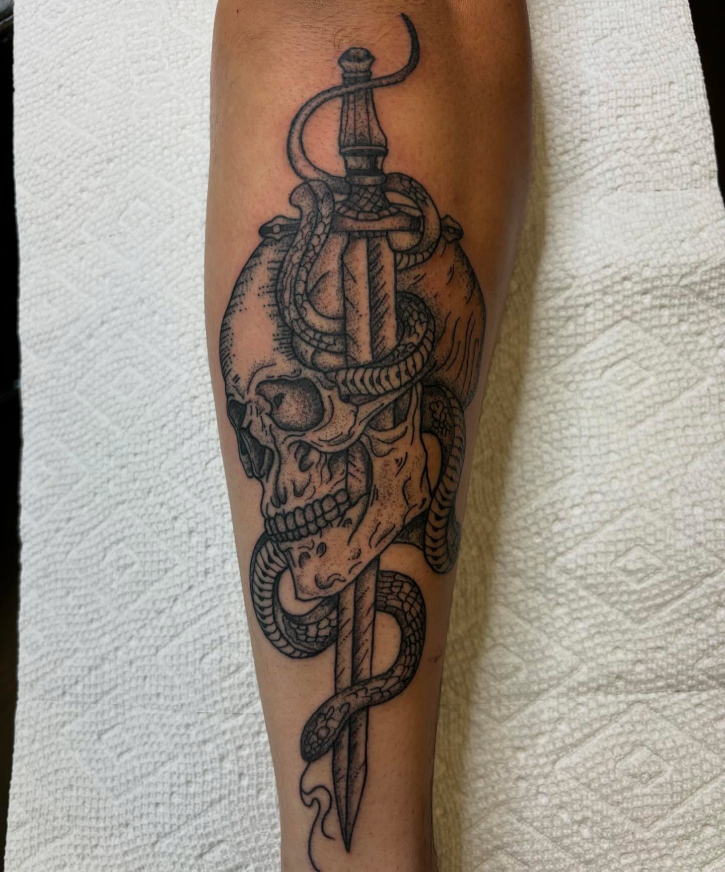 Skull and dagger realism tattoo on the forearm by Bryan Black
