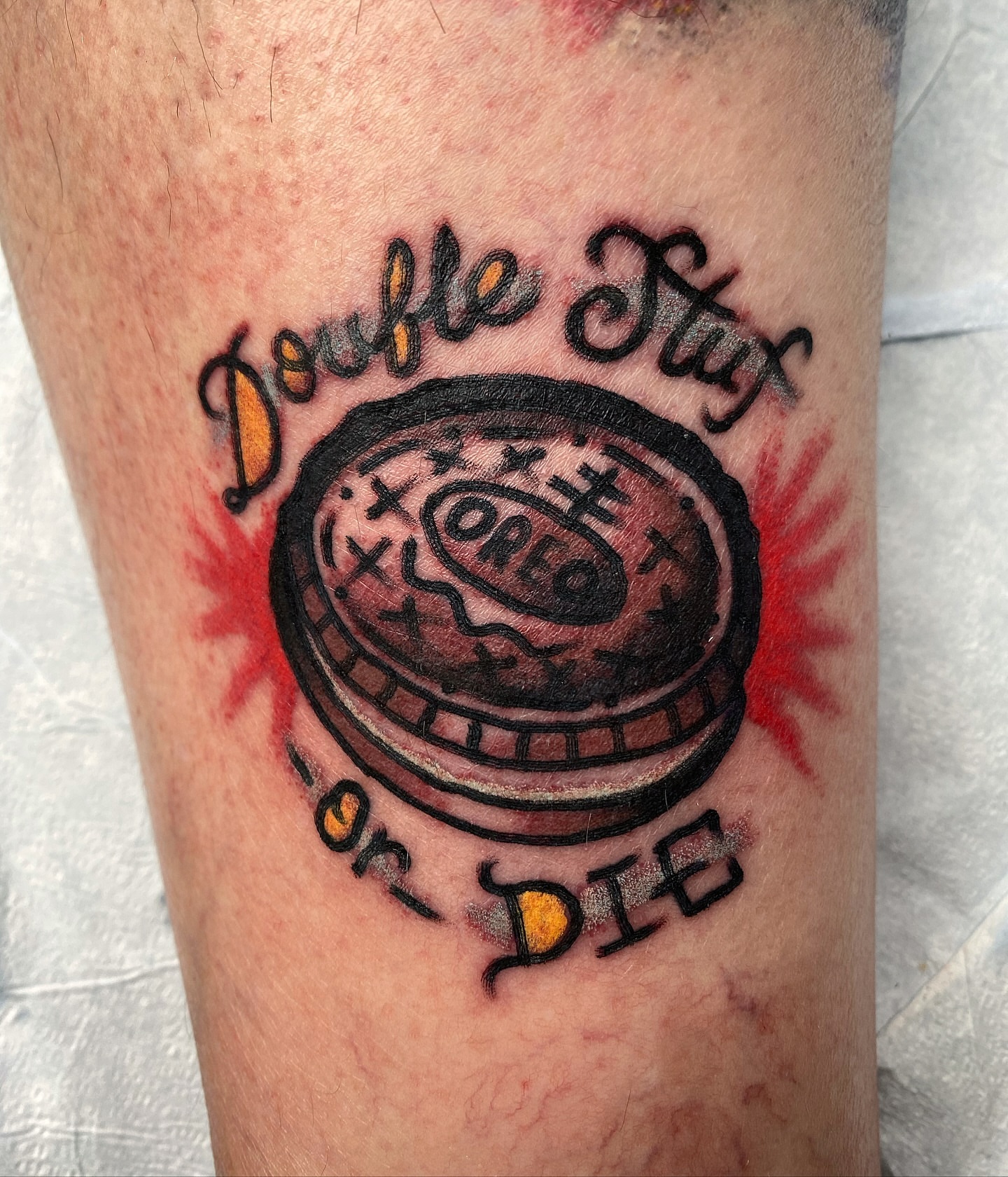 Oreo cookie American traditional tattoo on the forearm by Joey Delarosa, San Francisco, California