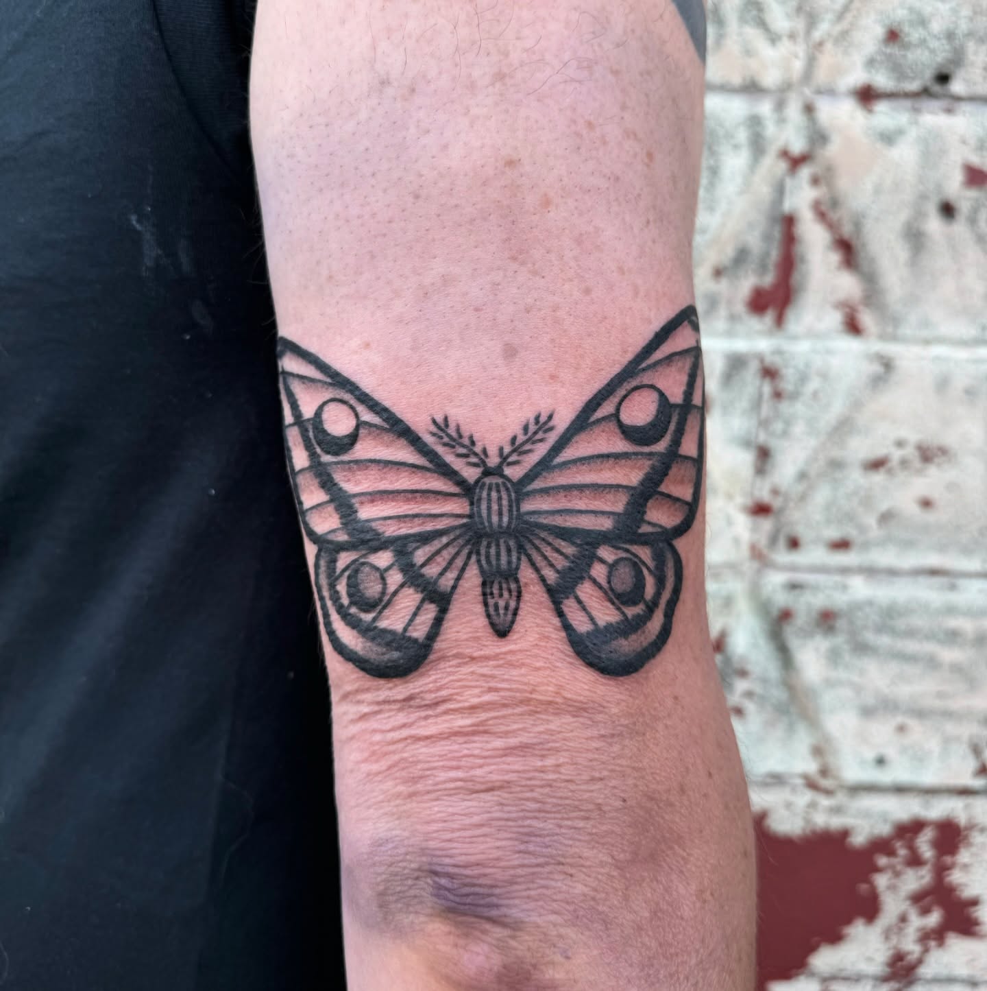 Butterfly black and grey tattoo on the forearm by Mazie