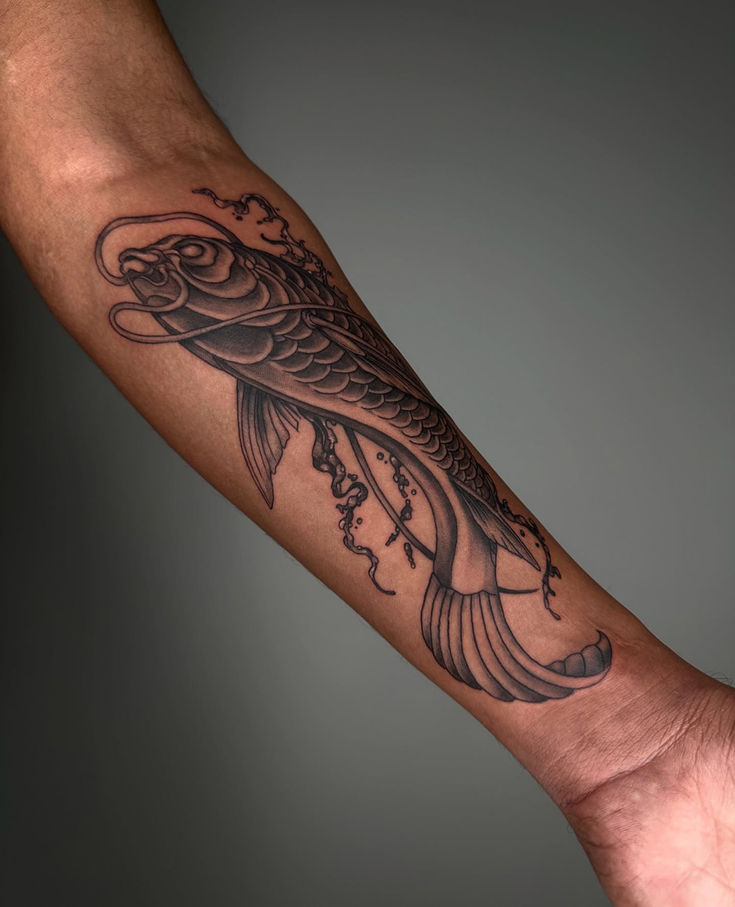 Koi fish black and grey tattoo on the forearm by A L e X