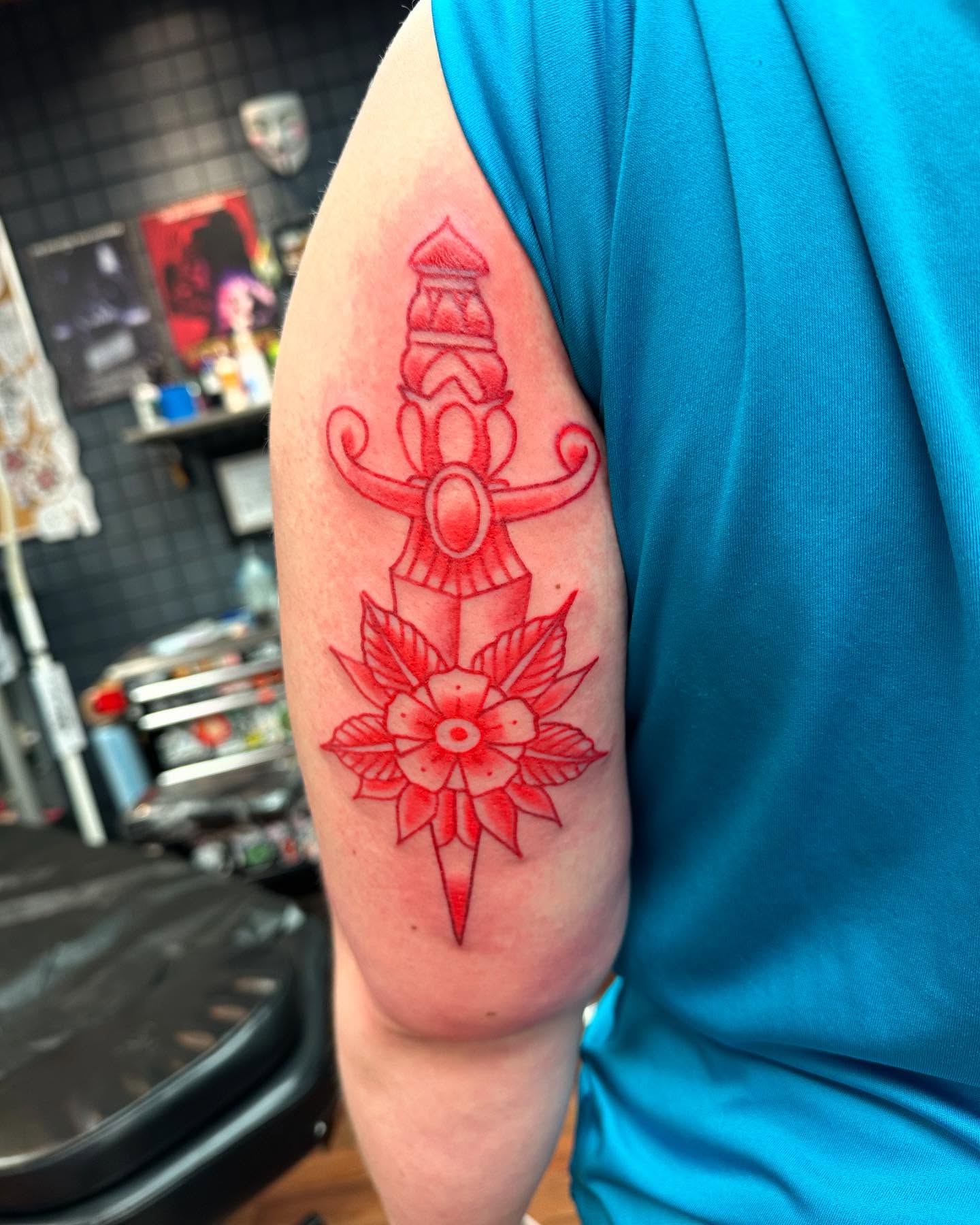 Sword and flower geometric tattoo on the forearm by Zach Eden