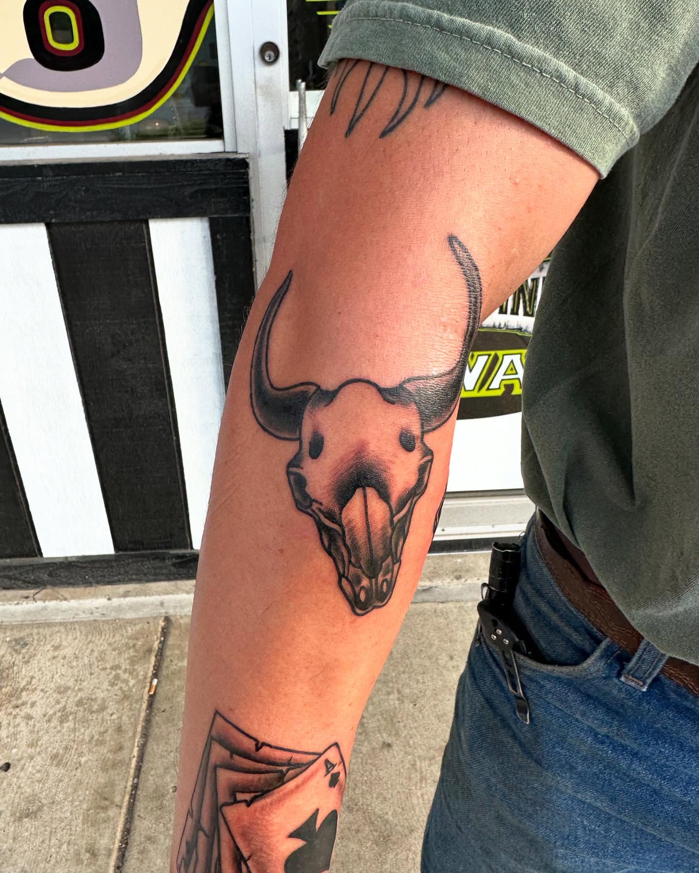 Bull skull realism tattoo on the forearm by Zach Eden