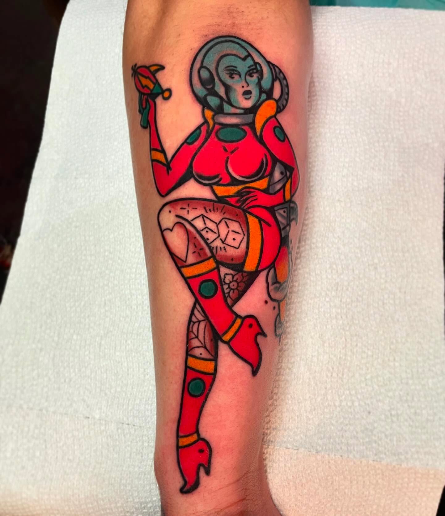 Cosmic pin-up girl American traditional tattoo on the forearm by Jacob, Marion, Illinois