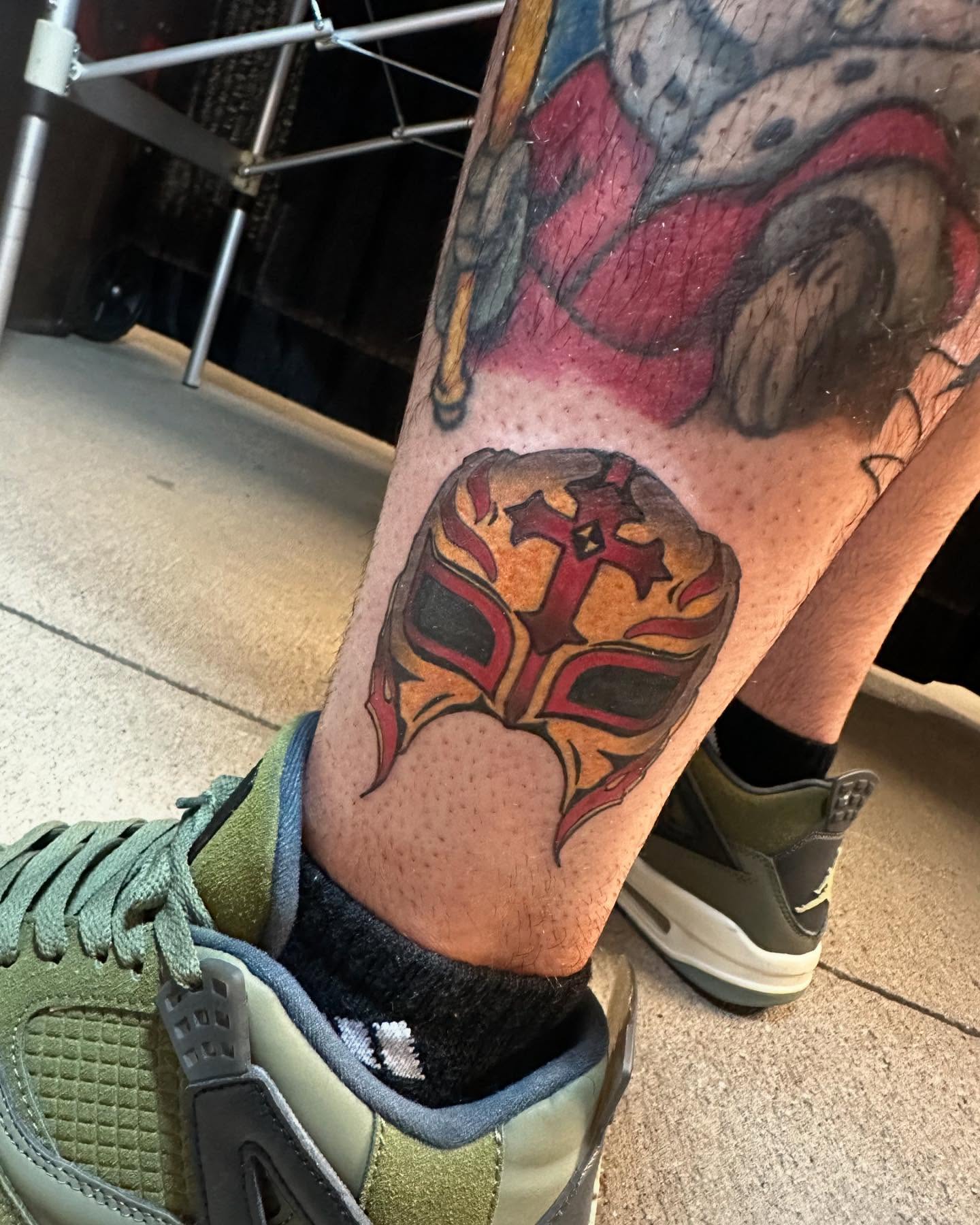 Mask American traditional tattoo on the forearm by Lexi Wilkinson