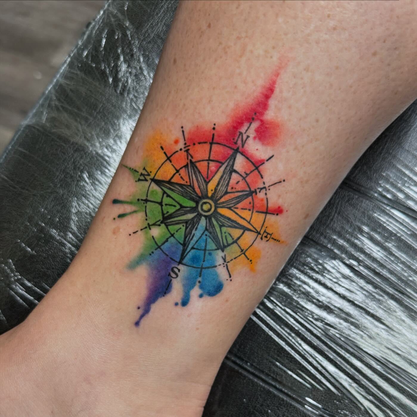 Compass watercolor tattoo on the forearm by Robyn Mahon