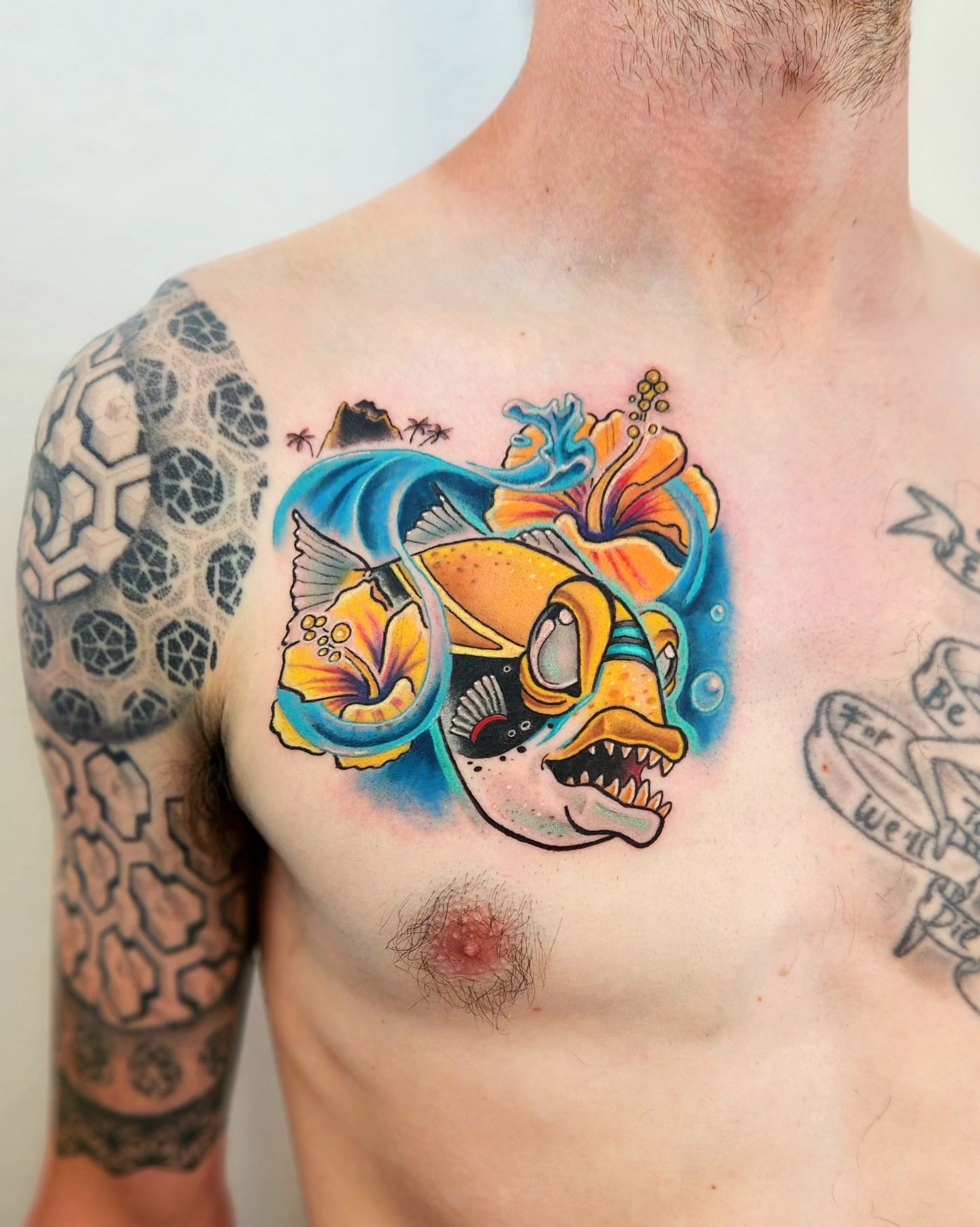 Fish and hibiscus American traditional tattoo on the chest by Elizabeth Stepp