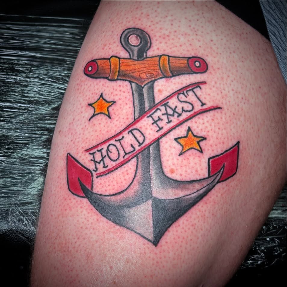 Anchor with ribbon American traditional tattoo on the thigh by Bobby Glennon
