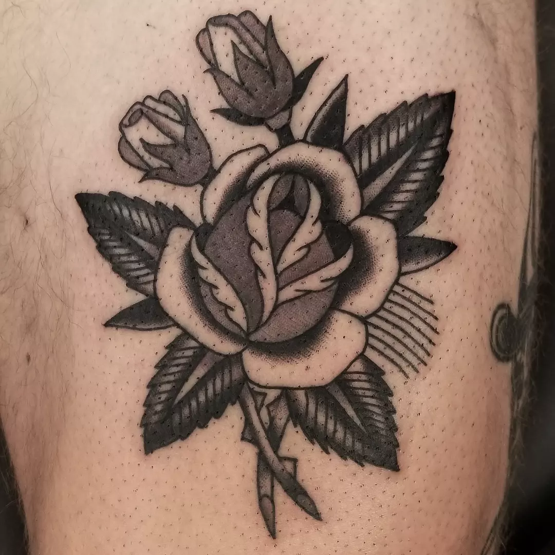 Rose American traditional tattoo on the thigh by Deke Harms, Bend, Oregon