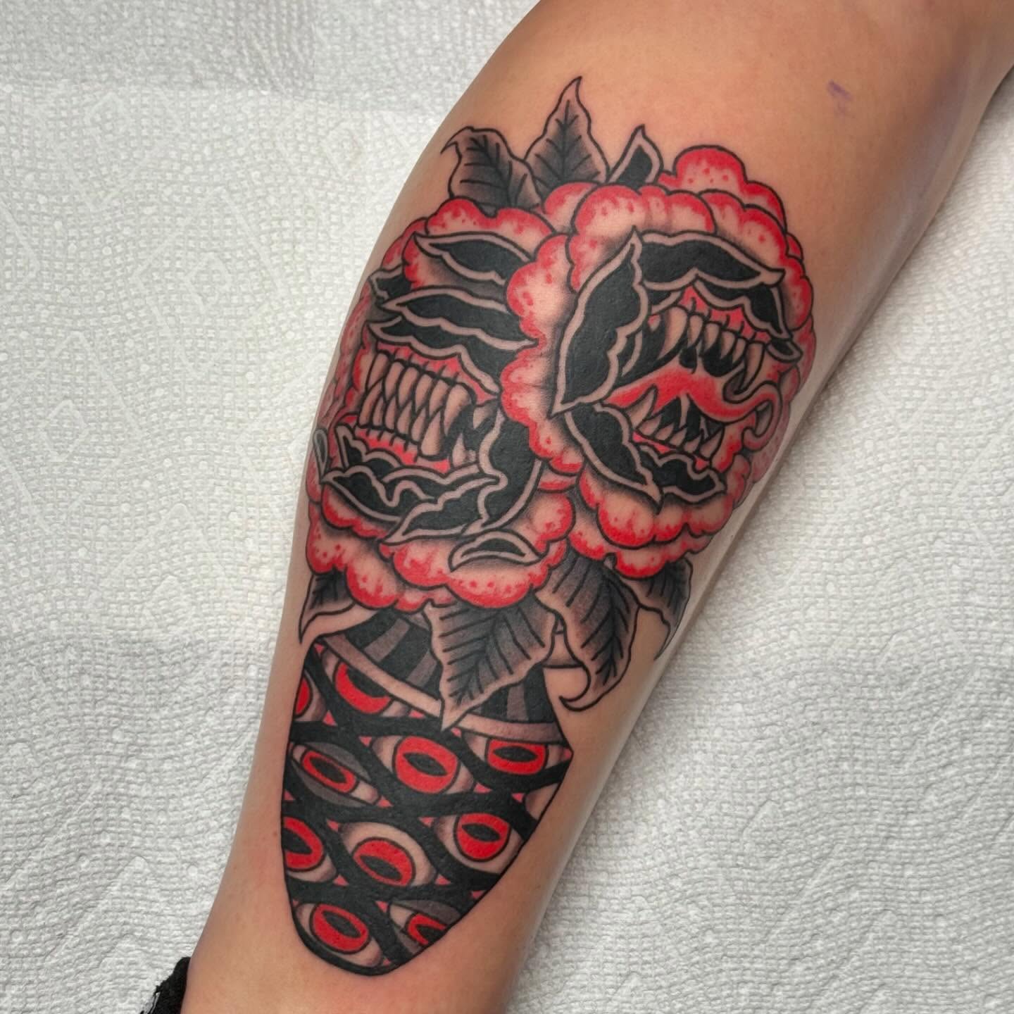 Skulls and roses American traditional tattoo on the forearm by David Gottschalk