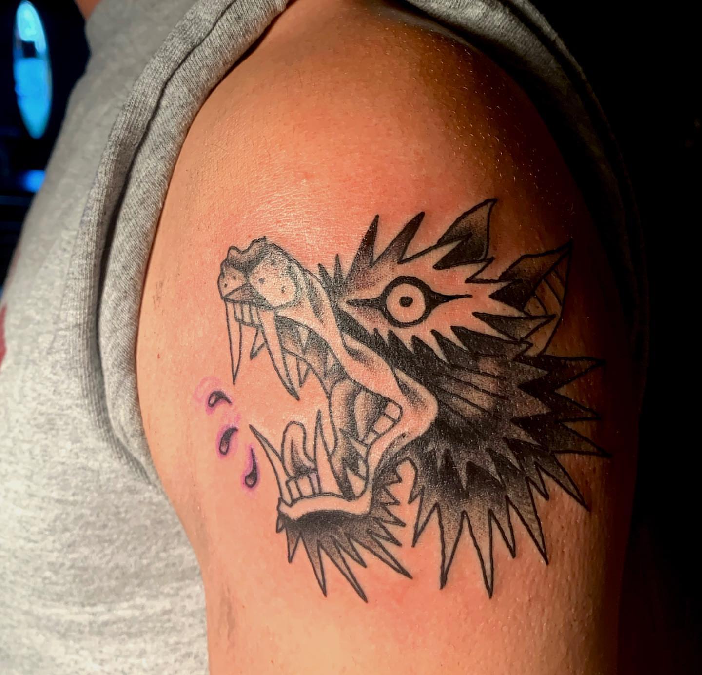 Wolf black and grey tattoo on the shoulder by Nolan Croteau
