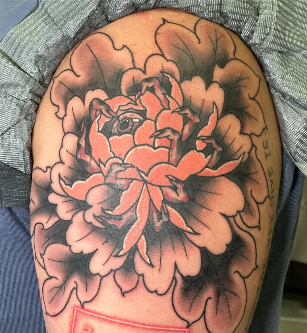 Peony with eye neo-traditional tattoo on the shoulder by Wesley Lam