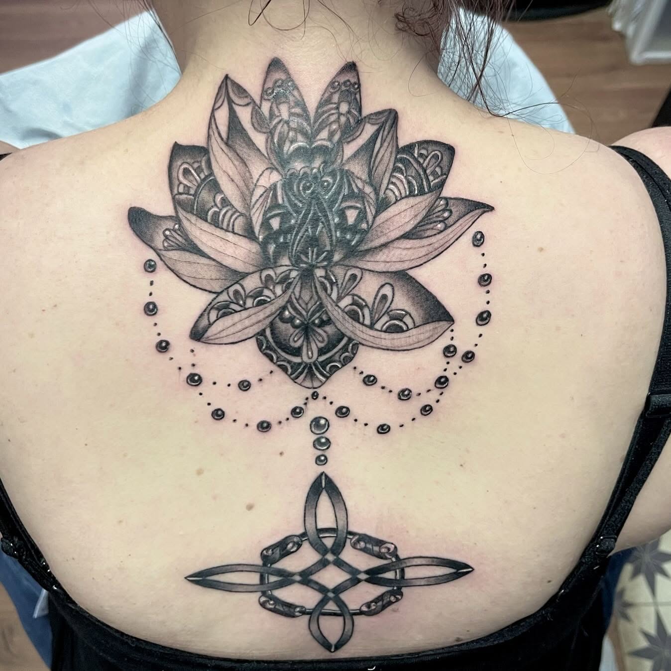 Lotus flower dotwork tattoo on the back by Ashly Hutchens, Richmond, Virginia