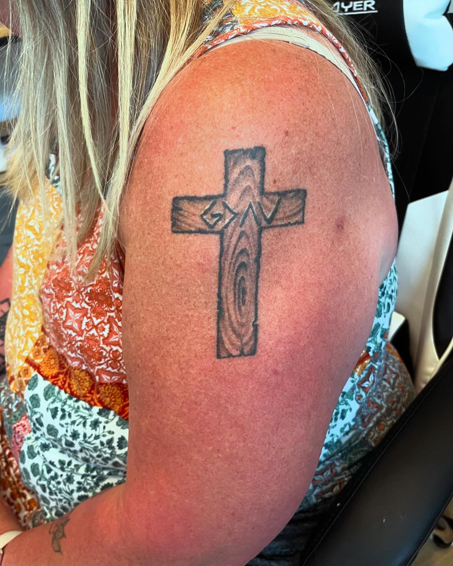 Cross black and grey tattoo on the shoulder by Val Maughan