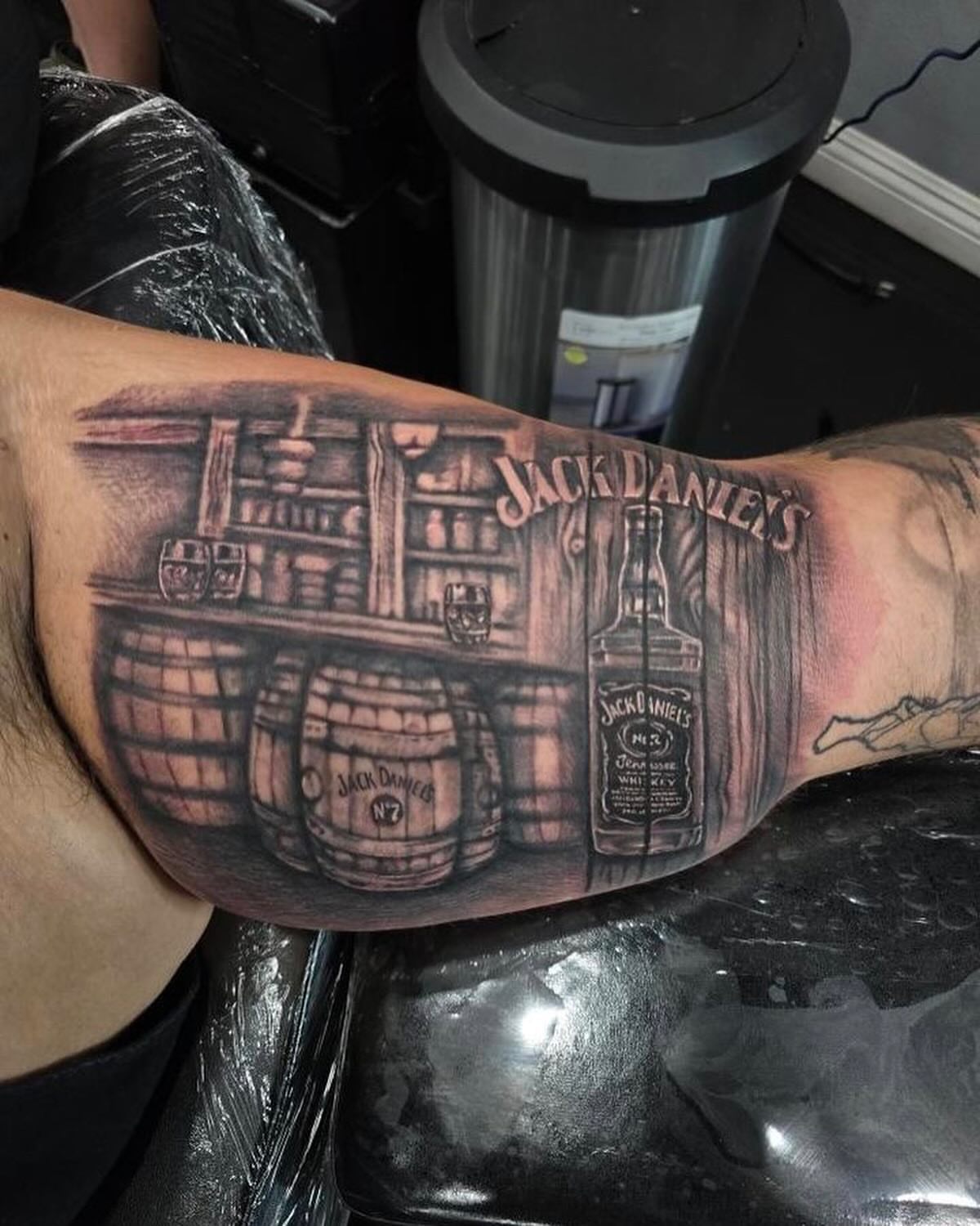 Jack Daniel's branding realism tattoo on the forearm by Lissy Red