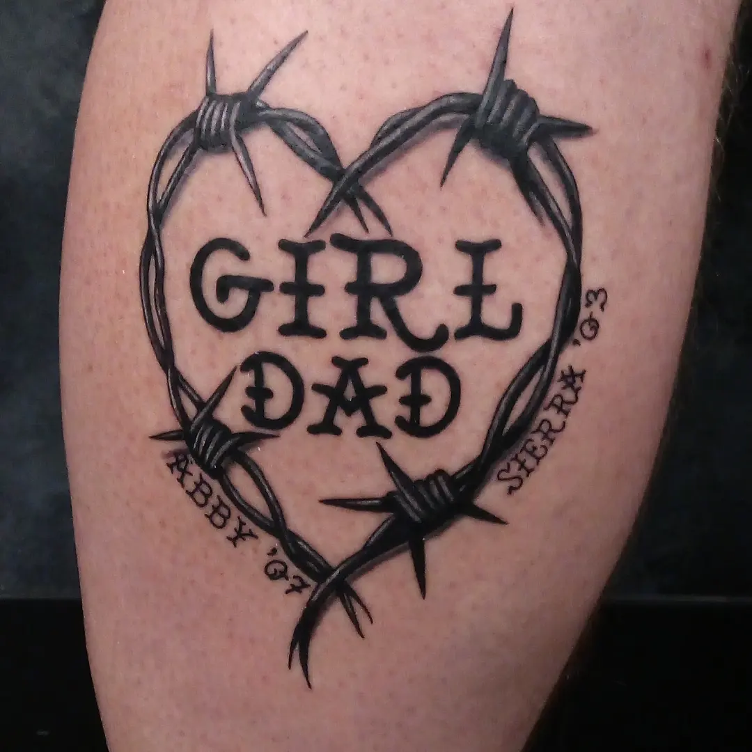 Barbed wire heart black and grey tattoo on the forearm by Cassandra Davis