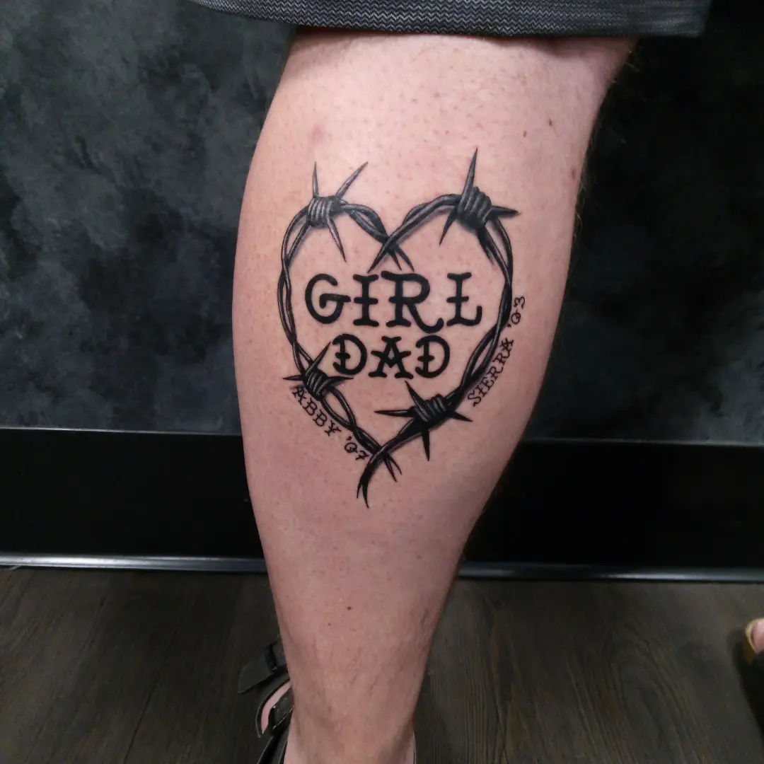 Barbed wire heart black and grey tattoo on the thigh by Cassandra Davis