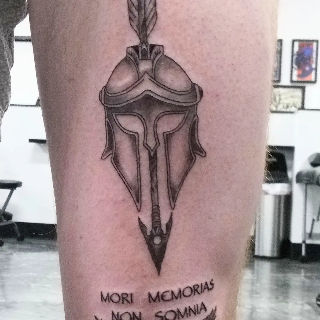 Spartan helmet and spear geometric tattoo on the forearm by Cassandra Davis