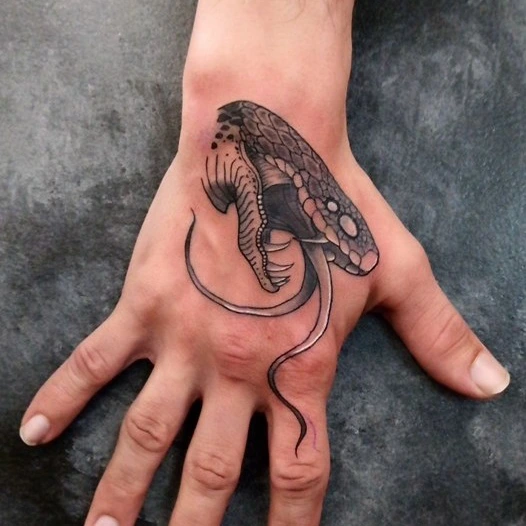 Snake dotwork tattoo on the hand by Cassandra Davis